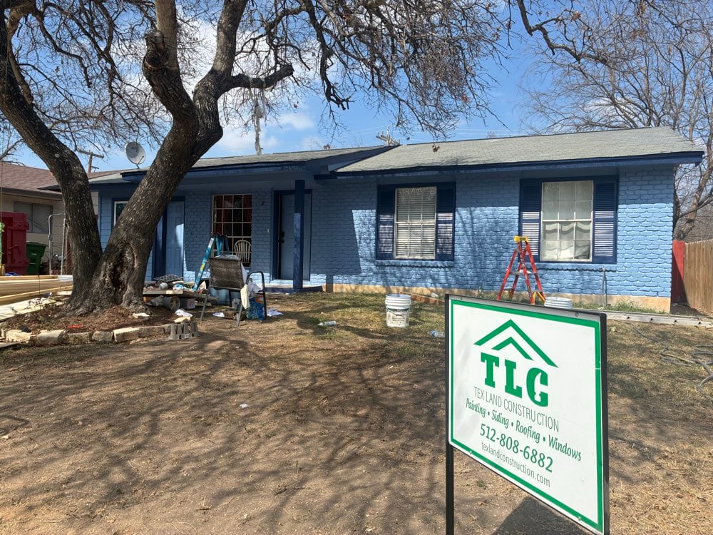 Blue painted brick ranch home in Austin TX with original windows and shutters before window replacement