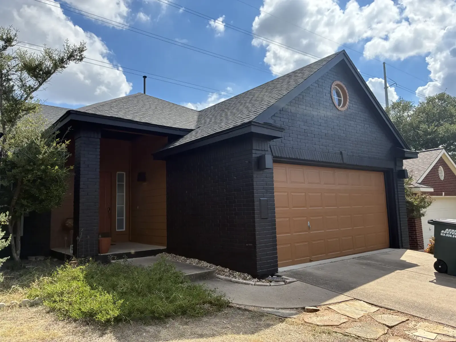Dark exterior walls beside a wood garage door