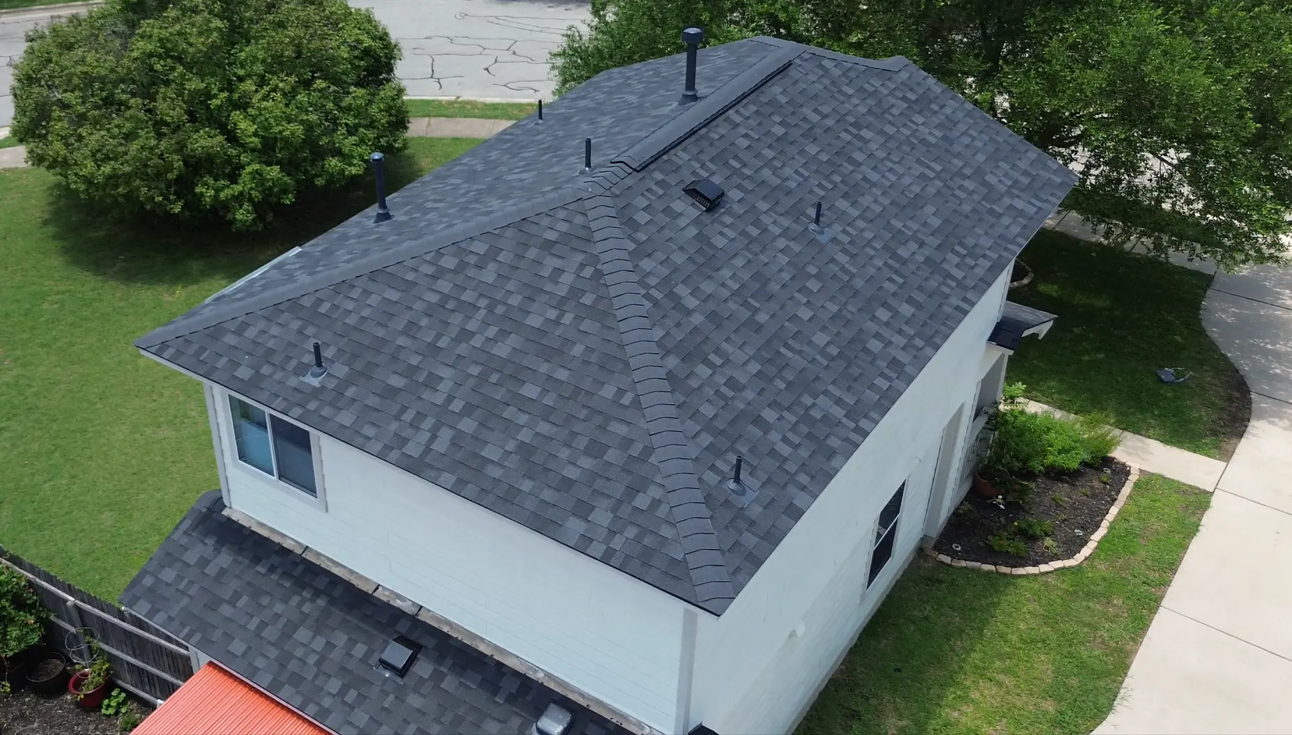 Gray shingle roof above a white house