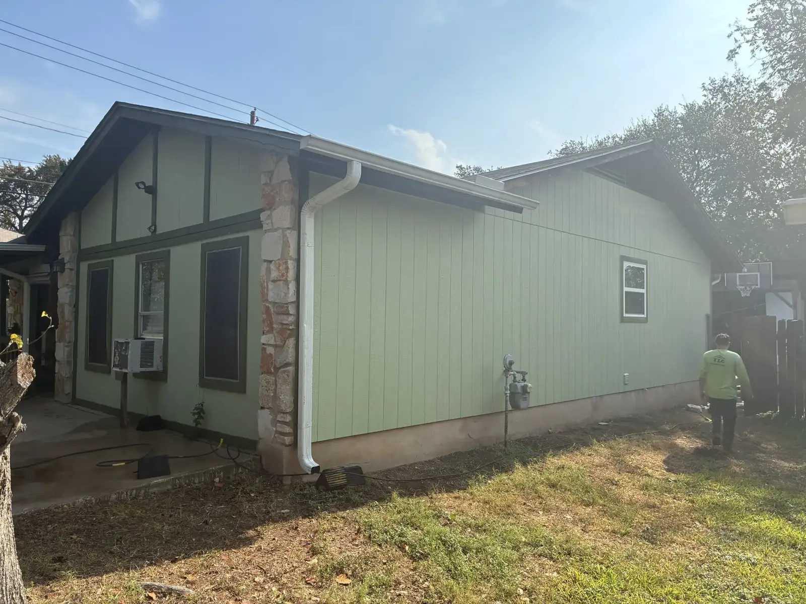 Pale green vertical siding with dark trim