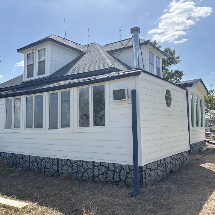 White horizontal siding and windows on a sunroom