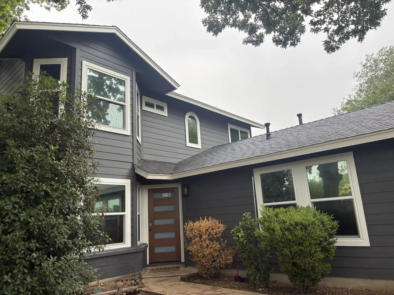 Modern gray sided home with white window trim