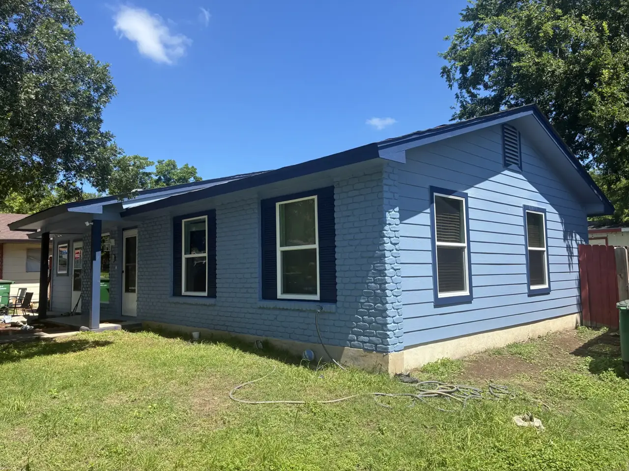 Blue sided house with white trimmed windows